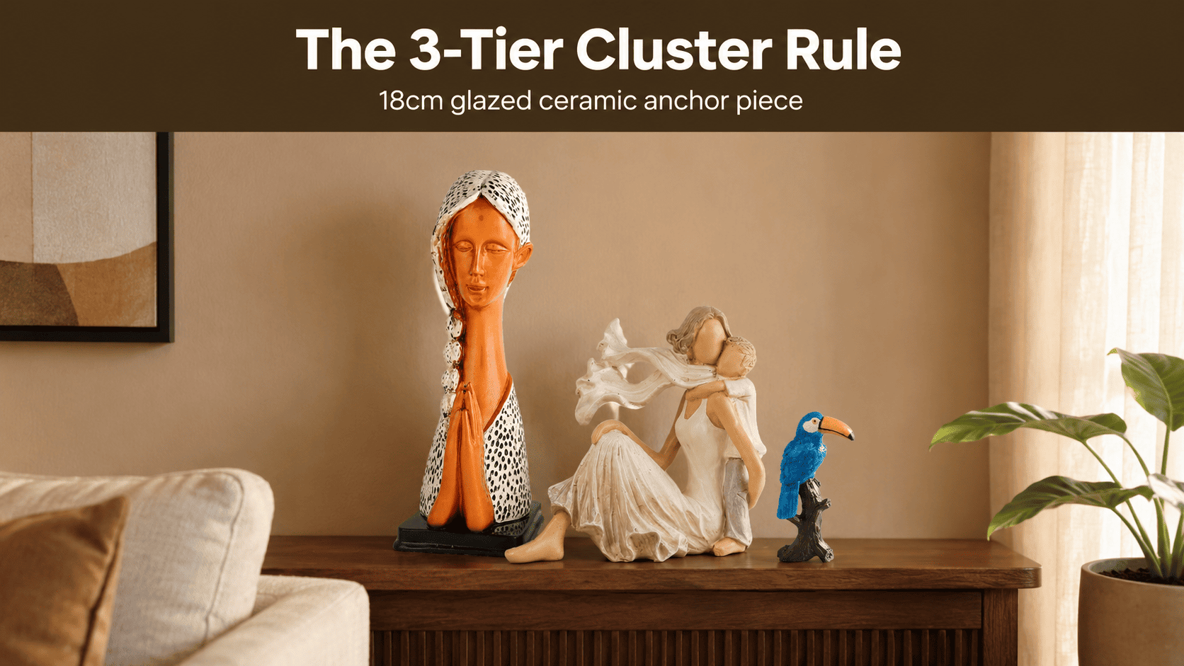 grouped ceramic and resin décor pieces on a console table at varied heights