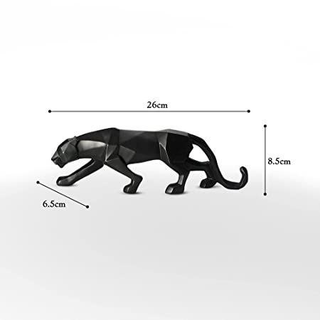 Black Panther Statue positioned on a kitchen countertop beside a vase of fresh green herbs.