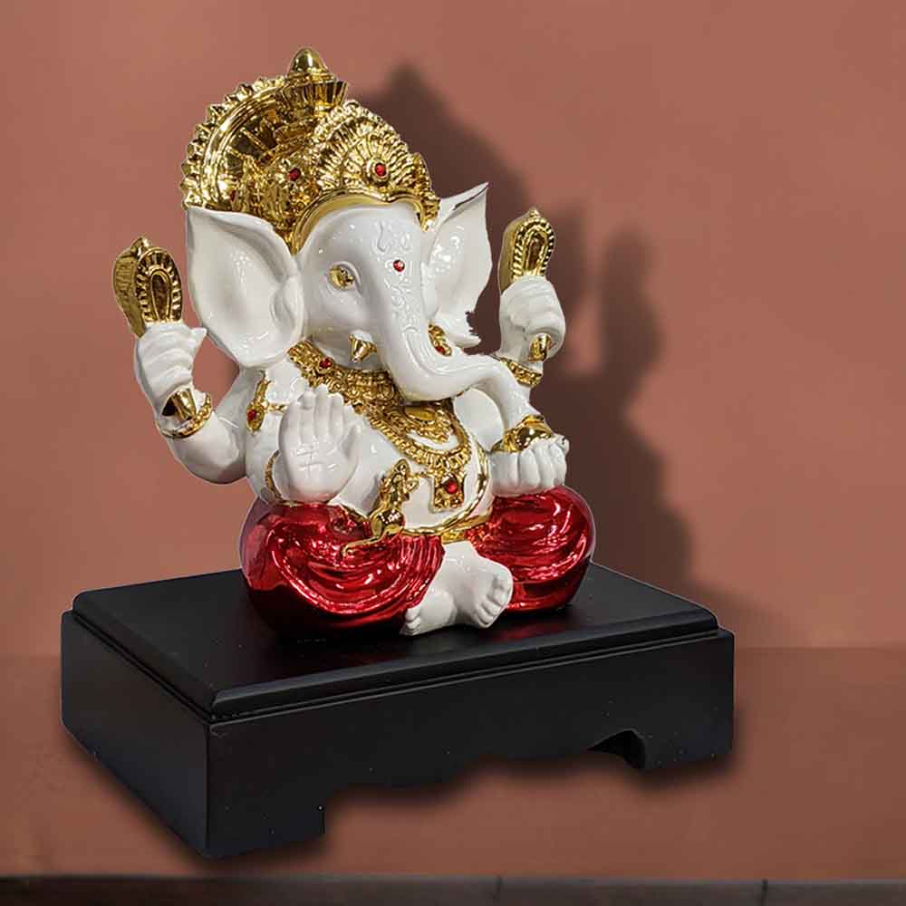 Sittng Golden Ganesh Idol wearing Red Dhoti for Ganpati Festival Decoration and Pooja