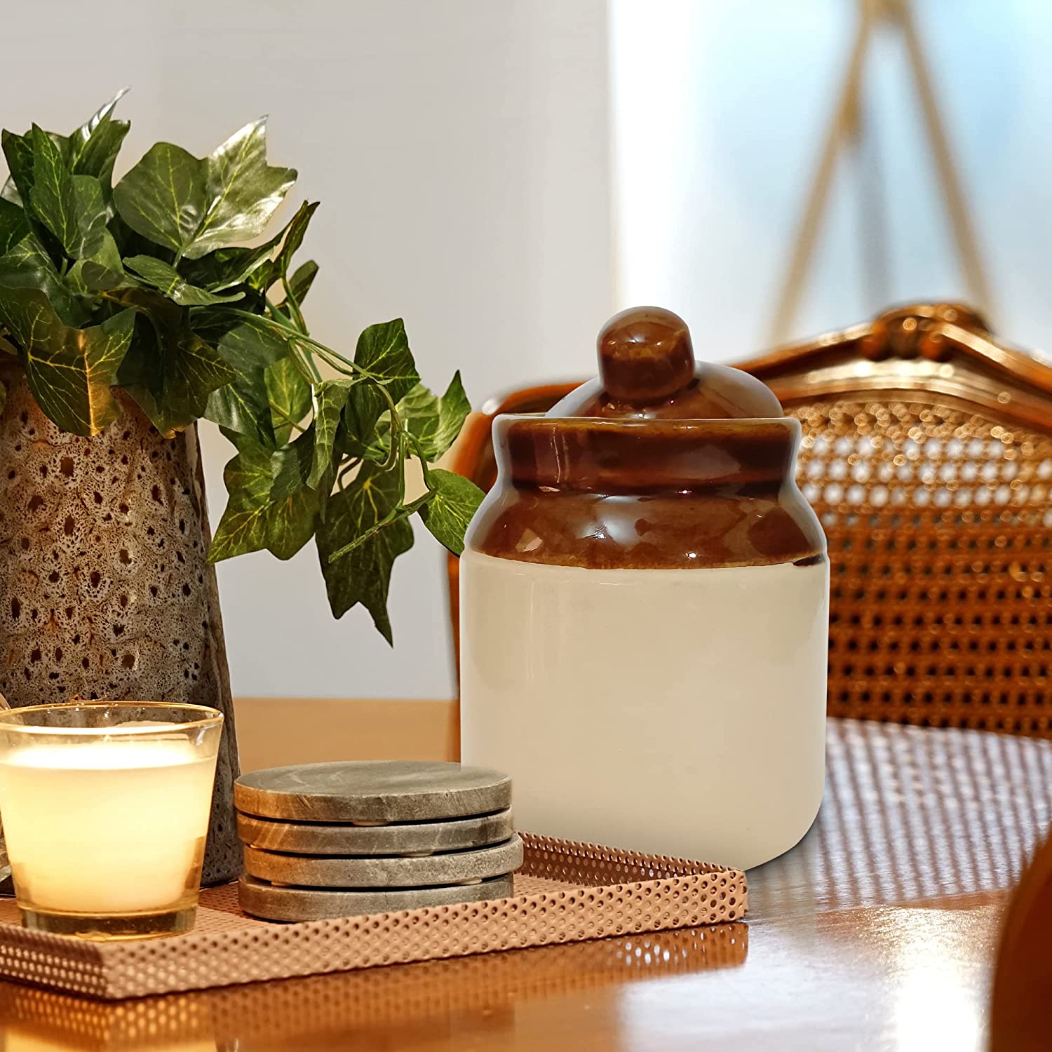 Yellow Ceramic Jar with Lid (Set of 2) displayed on kitchen counter with sunlight casting a warm glow on the vibrant color.