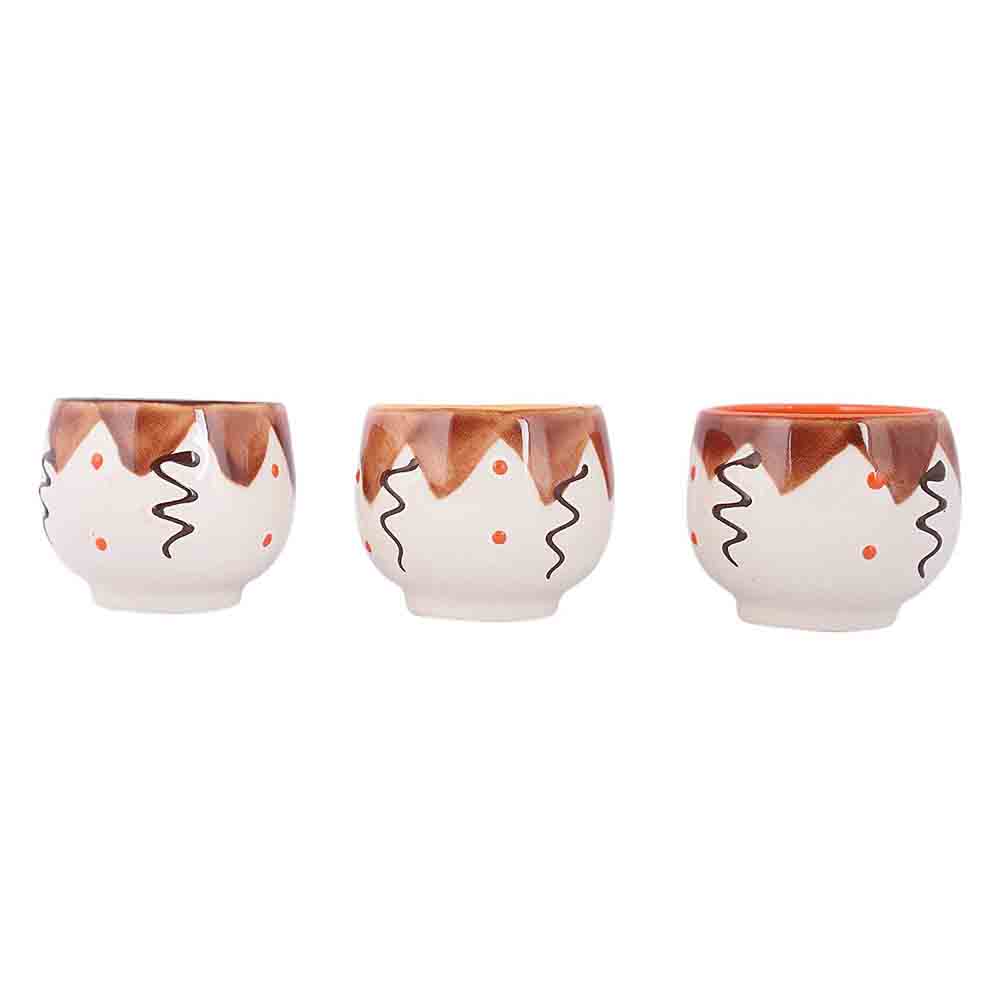 Hand-painted brown design on white ceramic tea cup with unique pattern inside