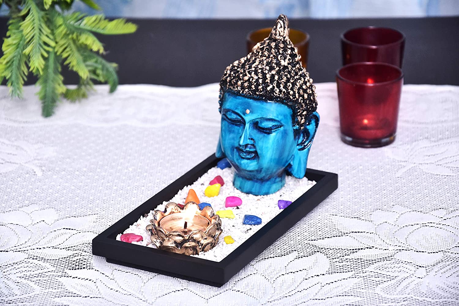 325832-top-blue-and-antique-silver-buddha-face-showpiece-on-wooden-tray-with-pebbles-and-one-tealight-holder-online.jpg
