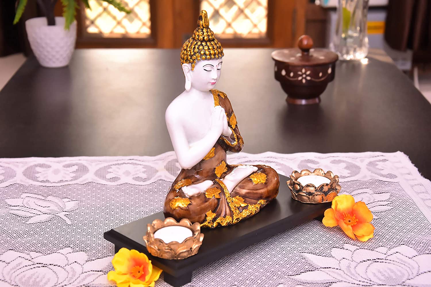 325834-top-buddha-showpiece-in-prayer-pose-sitting-on-a-wooden-platform-with-two-tealight-holders-india.jpg