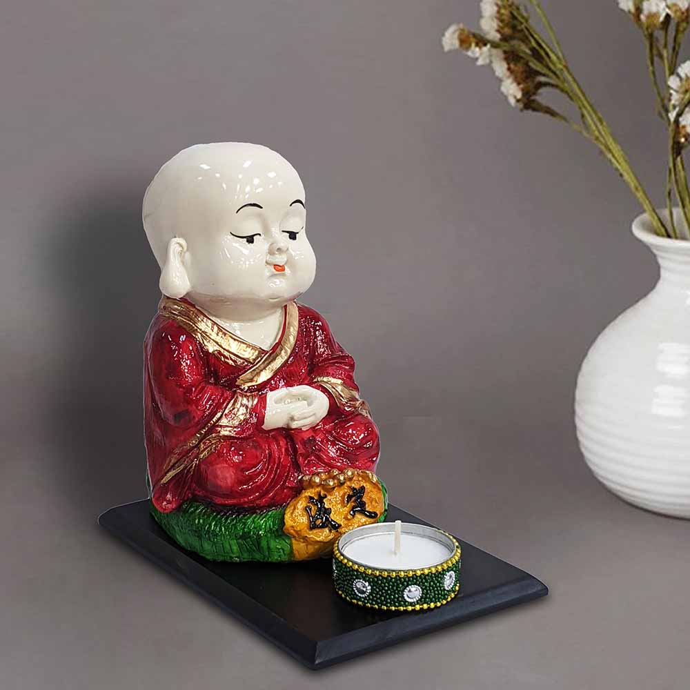 325887-top-miniature-red-baby-monk-buddha-sitting-showpiece-on-a-wooden-tray-with-a-tealight-holder-india.jpg