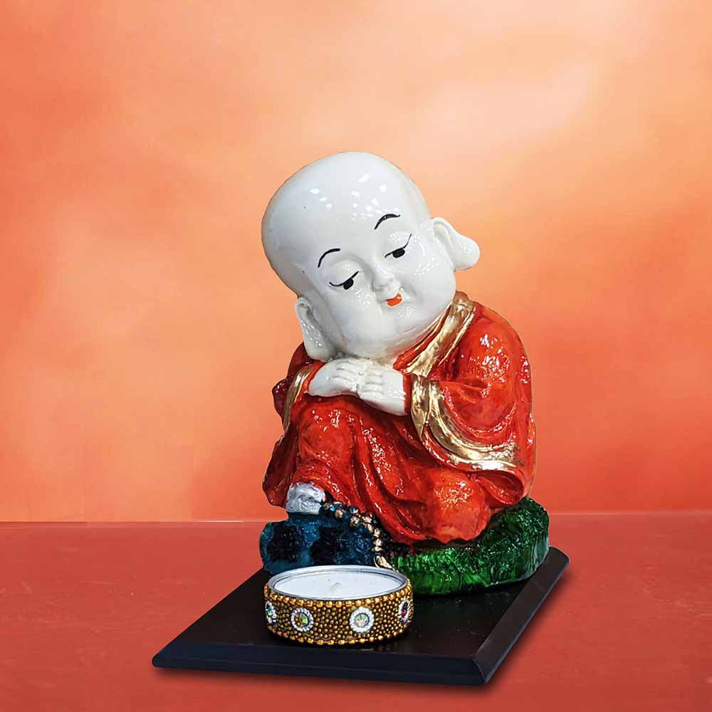 325888-top-miniature-orange-baby-monk-buddha-sitting-showpiece-on-a-wooden-tray-with-a-tealight-holder-india.jpg