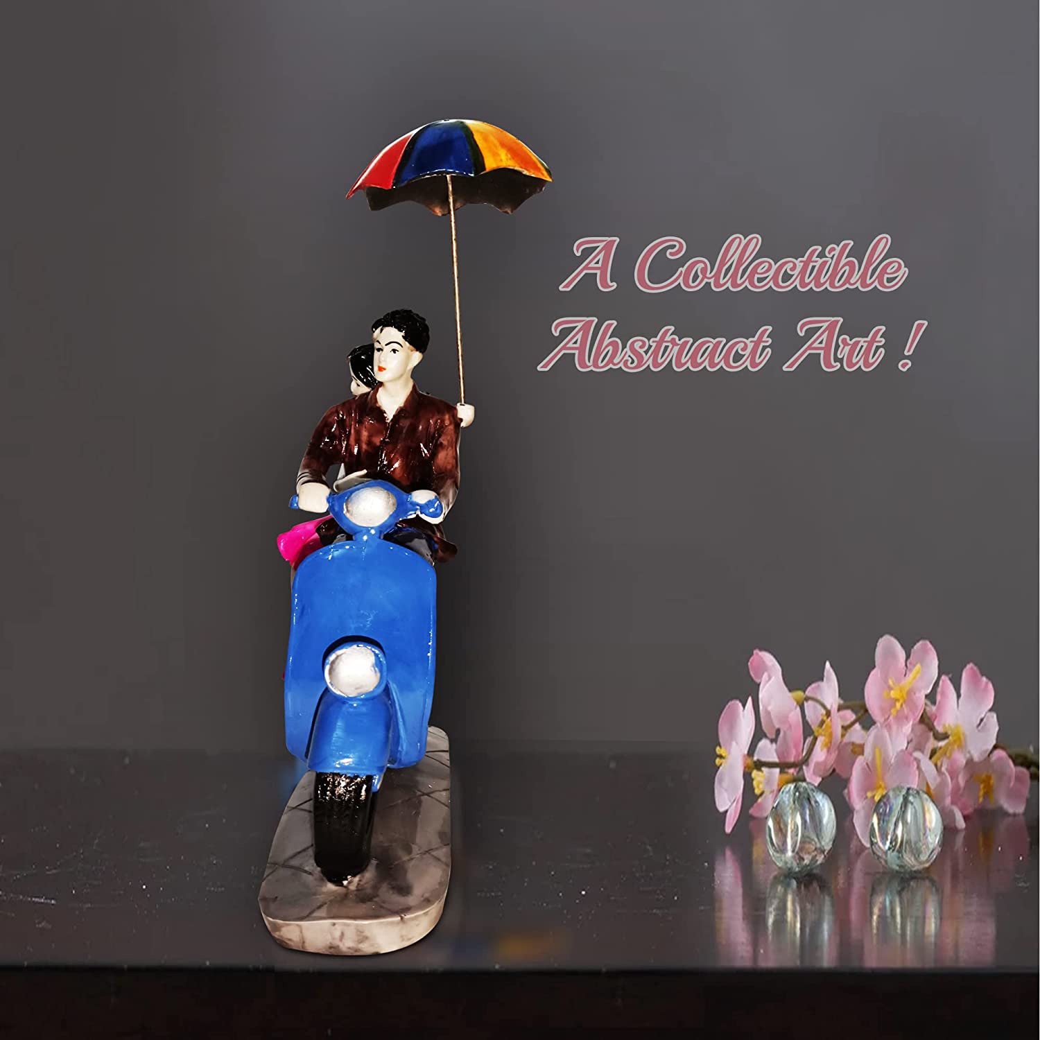326154-top-couple-statue-of-a-couple-sitting-on-a-scooter-with-umbrella-in-india.jpg
