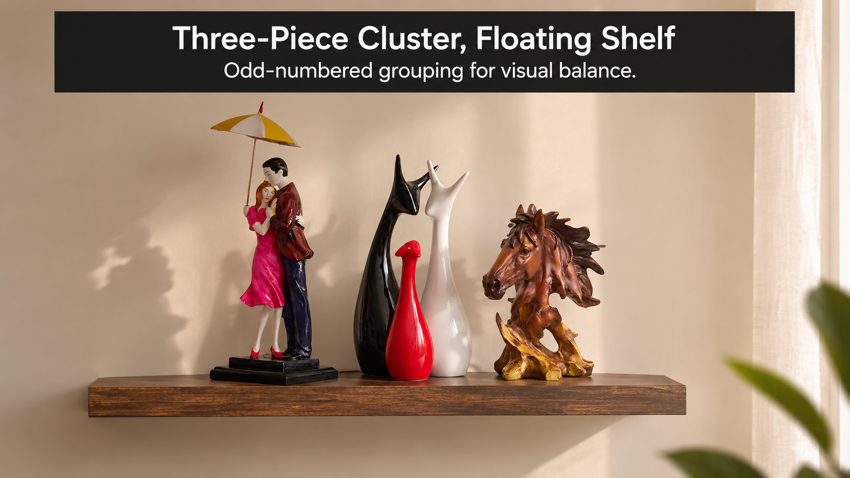 A cluster of three small decorative pieces grouped on a floating shelf