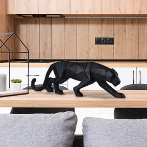 Modern black panther statue in geometric style for kitchen decor atop a marble countertop