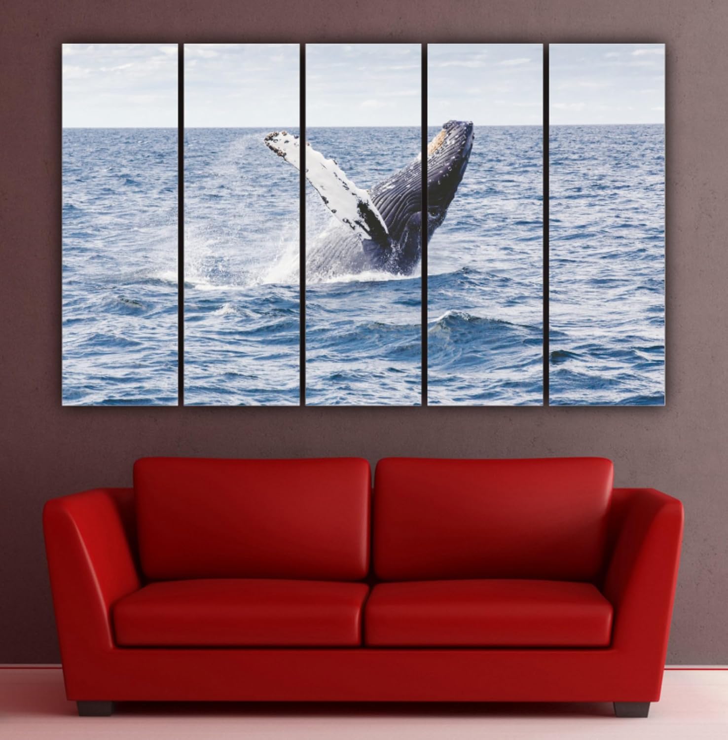 Vibrant fish and blue ocean waves printed on multi-panel framed wall art hung above a couch