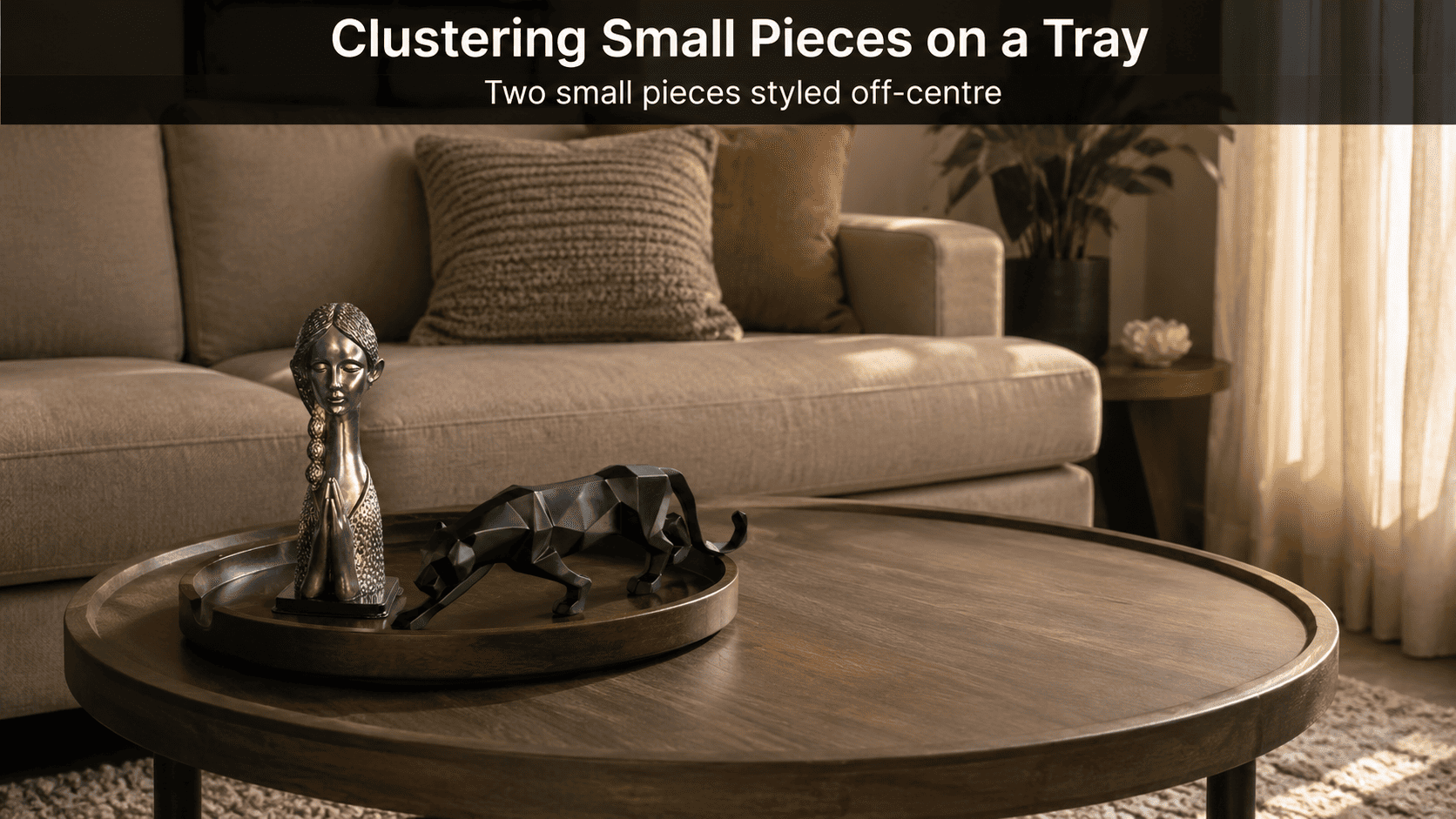 small tray styled with clustered decor pieces near sofa edge