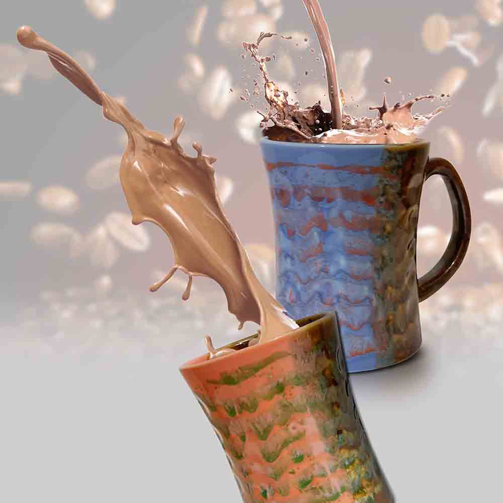Orange and Blue Coffee Mug with artistic brush strokes displayed in a natural kitchen setting.