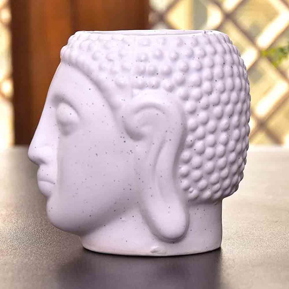 White Buddha Statue Planter placed on a kitchen counter with fresh herbs.