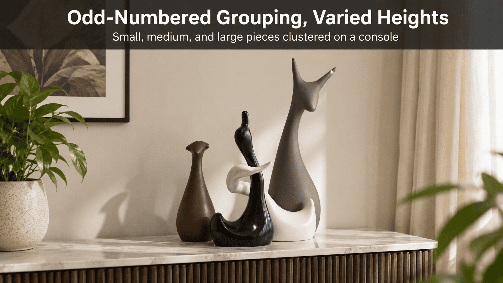 three home decor pieces of varying height clustered on a console