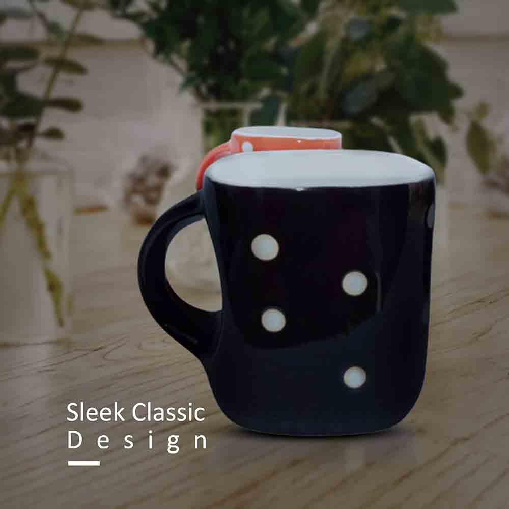 nullMulticolor ceramic tea cup with white dot patterns and a white interior displayed on a kitchen countertop.