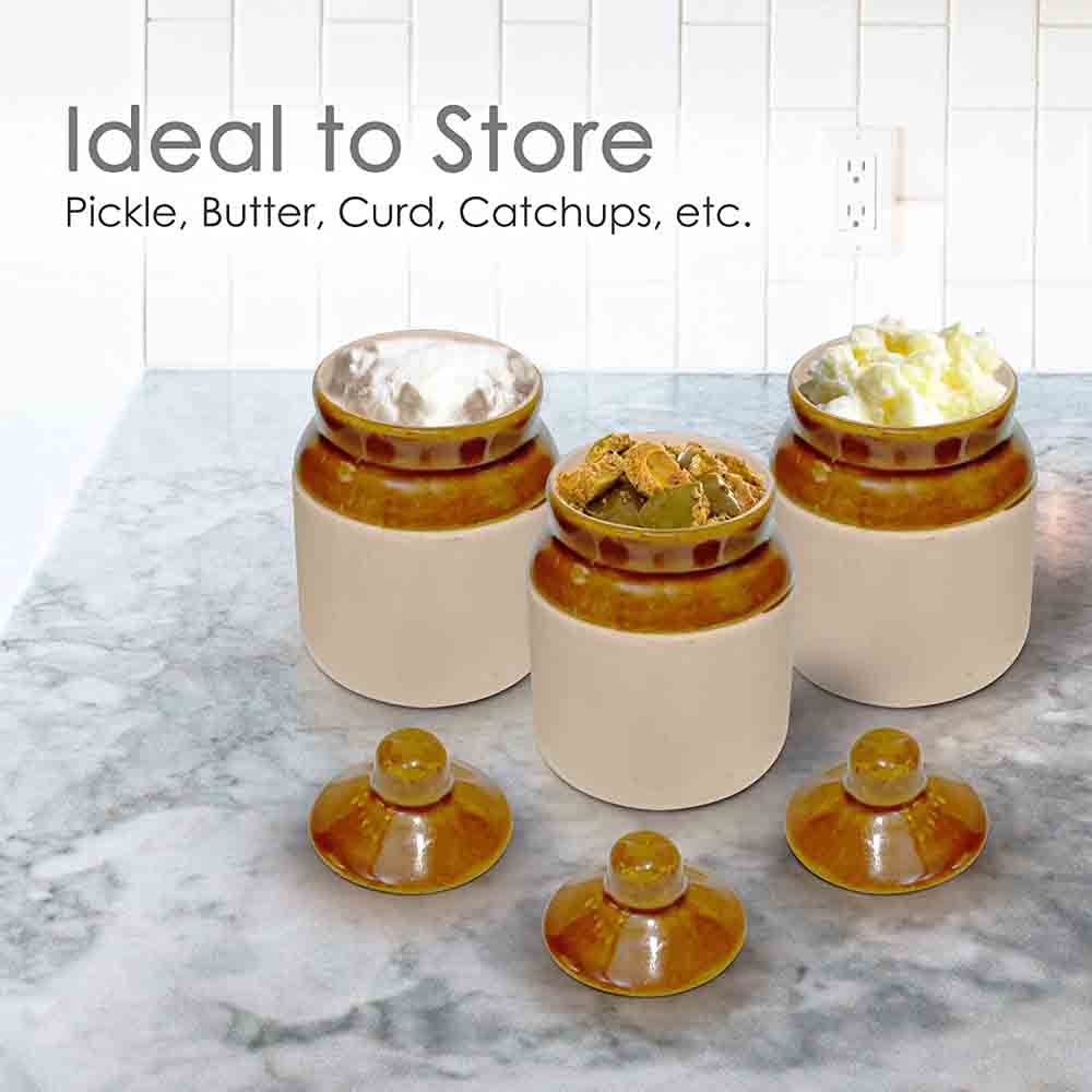 Brown and white ceramic pickle jar with snug-fitting lid displayed on kitchen countertop.