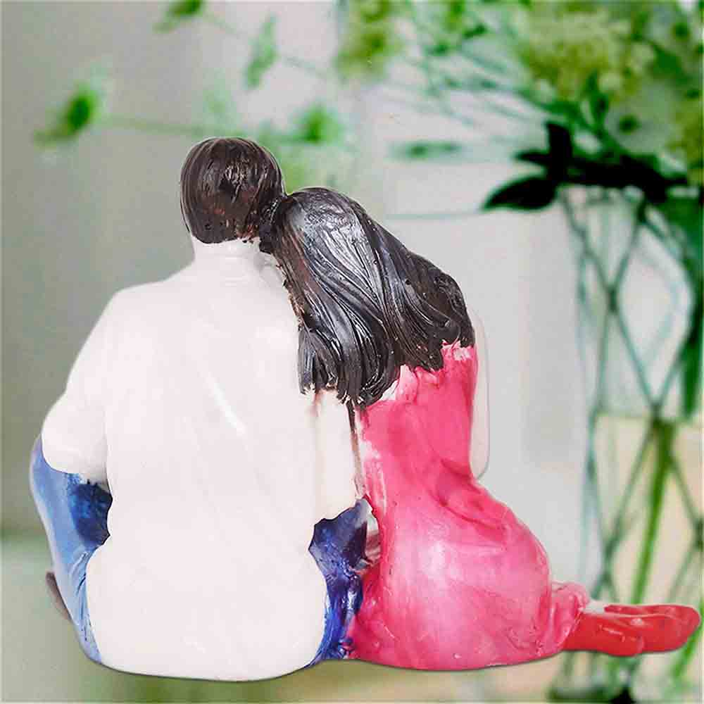Figurine Of Romantic Couple Sitting Together Online
