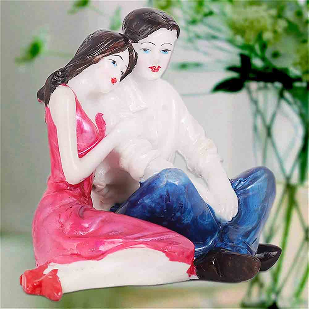Statue Of Romantic Couple Sitting Together For Display