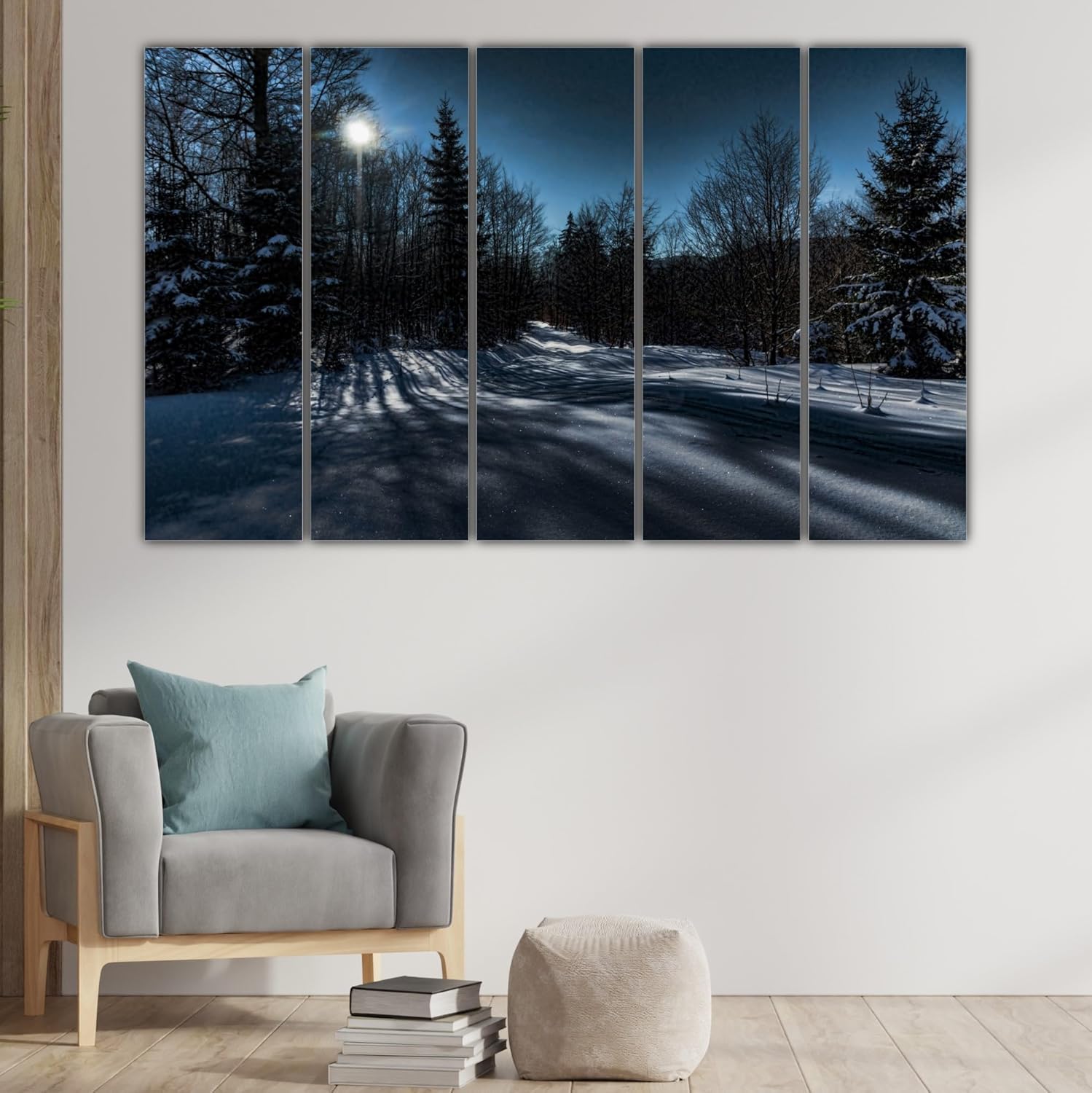 Close-up of framed multi-panel snow photography wall art with crisp white and blue details.