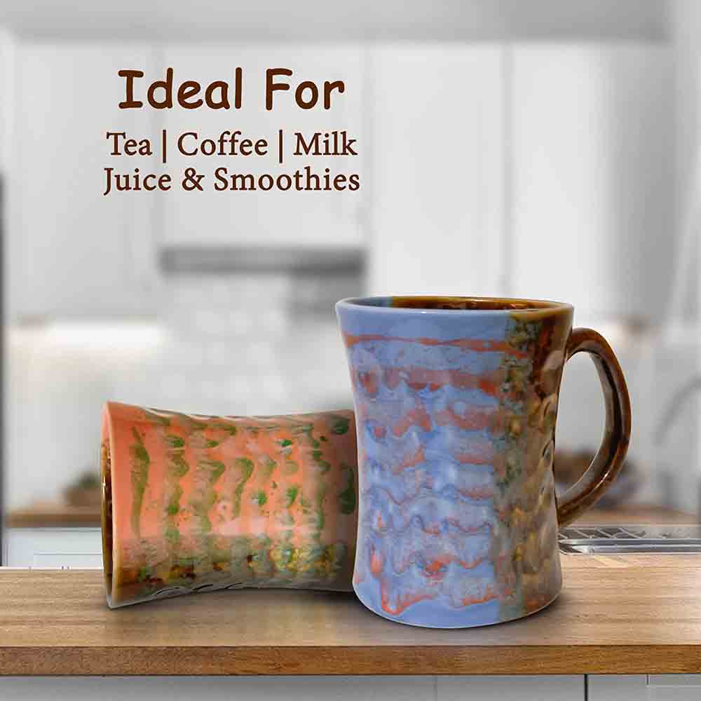 Orange and Blue Coffee Mug with artistic brush strokes displayed on a kitchen countertop.