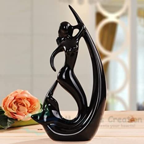 Black and Red Fish Angle Statue with a glossy finish displayed on a modern kitchen countertop.