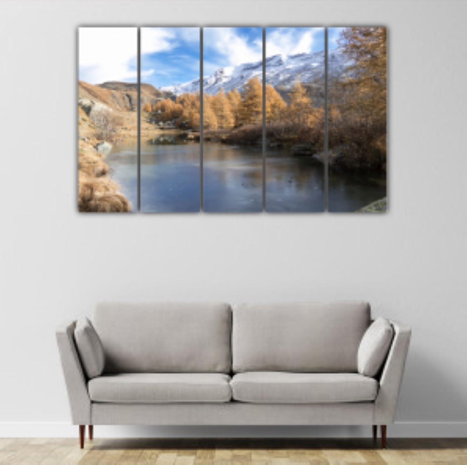 Wide view of the 5-panel framed wall art with lush nature scenery adorning a living room wall